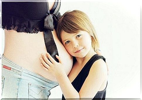 Girl hugs pregnant belly