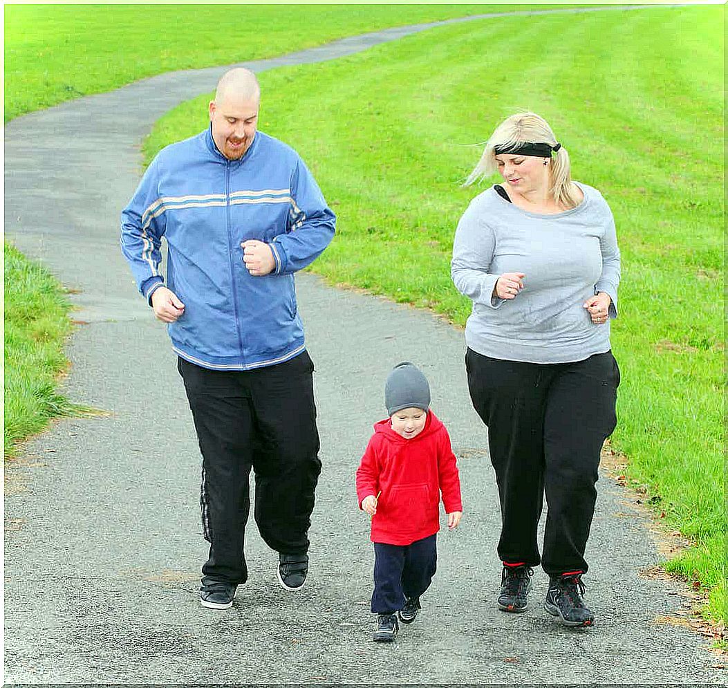 Obese parents running with their toddler