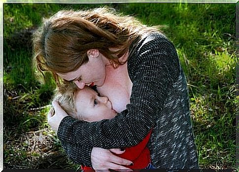 mother engaged in breastfeeding her child