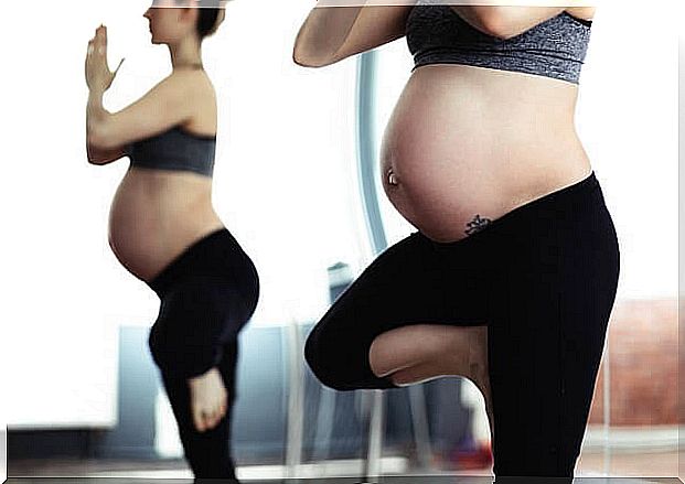 heavily pregnant woman doing yoga