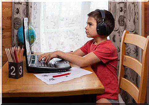 Boy at computer is learning to write