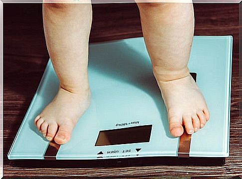 baby feet on a bathroom scale