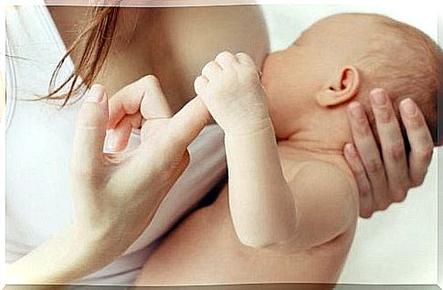 Baby holding finger