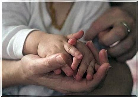 Massage of baby's hand against stress