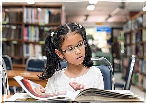 Girl reading a book at the library 