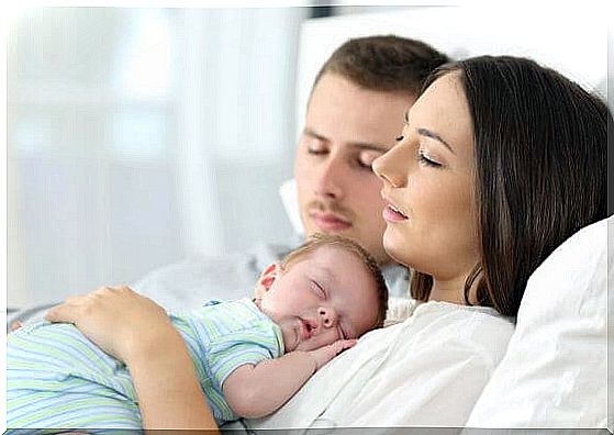 baby sleeping on mother's breast