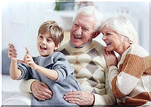 boy taking a picture with his grandparents