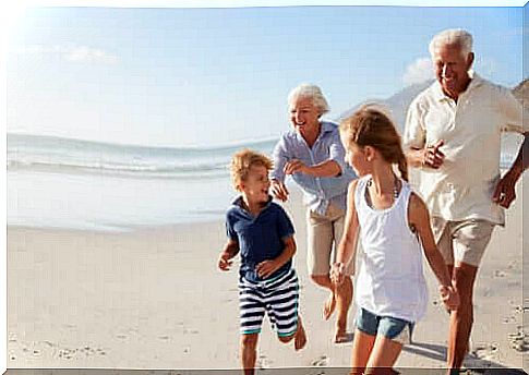 grandparents and children on the beach