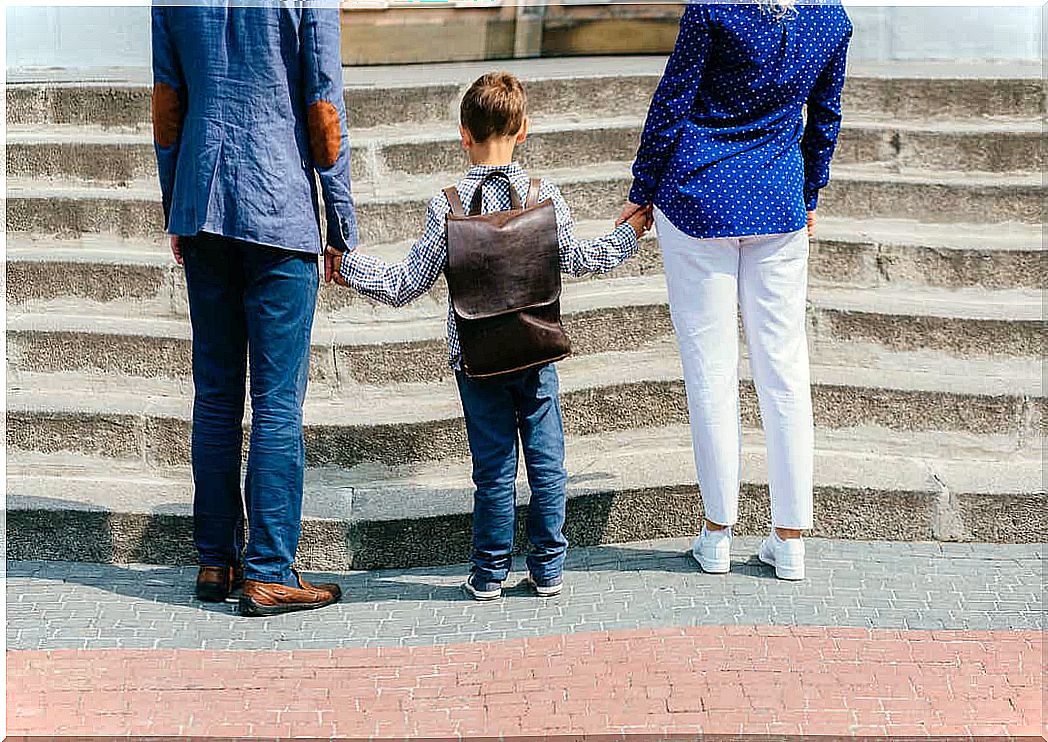 A mother and father send their children to school