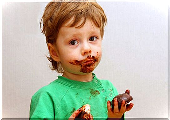 little boy with food on his mouth, on hands and clothes