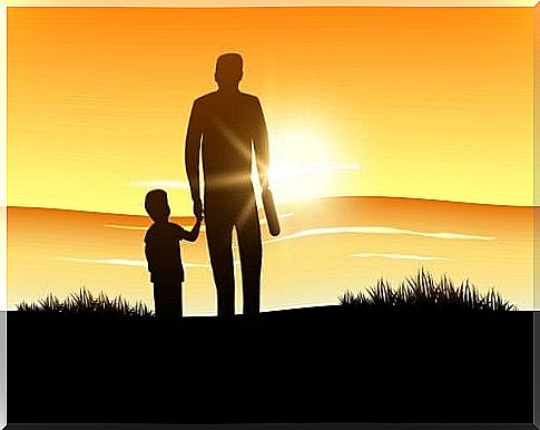 father and son watching sunset