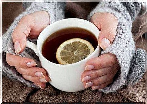 A hot cup of tea with a slice of lemon 