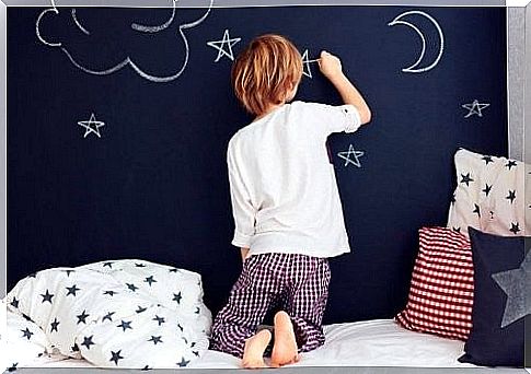 Child draws on chalk wall before bedtime 