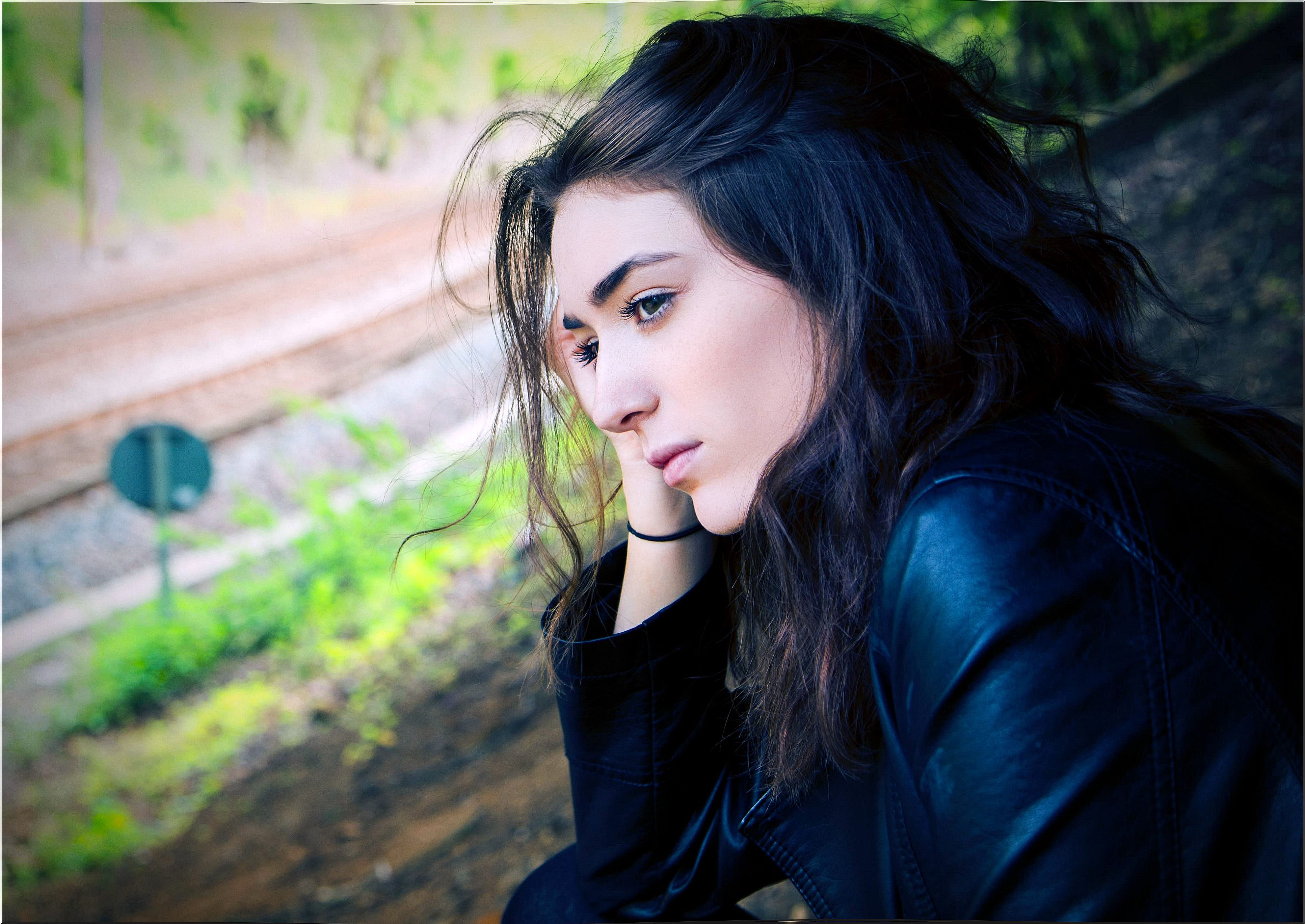 thoughtful woman sitting on a slope