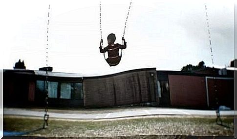 A boy swings alone