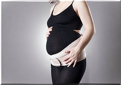 pregnant woman with support around the abdomen