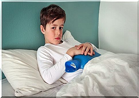 boy with hot water bottle on his stomach