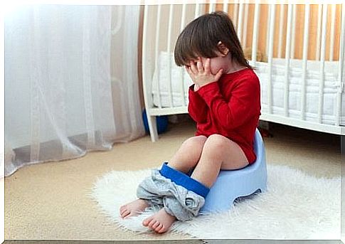 child sitting on potty