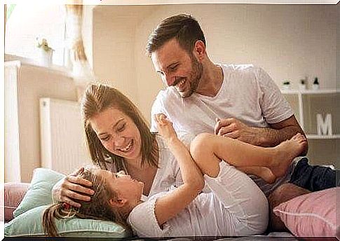 Mother, father and daughter laugh together