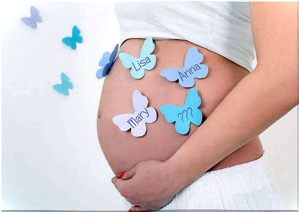 pregnant belly with butterfly notes with names