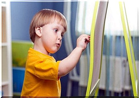 boy draws on blackboard