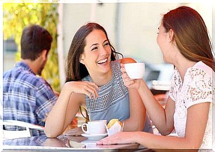 two women at cafe with coffee