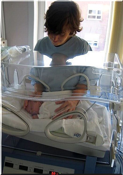 baby lying in incubator