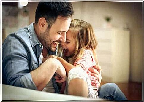 Time at home with family: Dad hugs girl