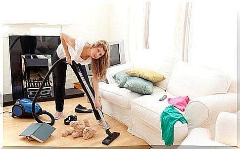 woman vacuums and cleans up the home