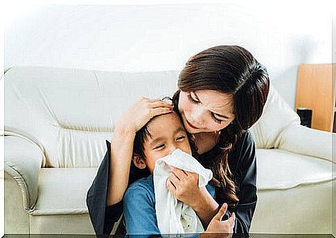 mother brushing her baby's nose