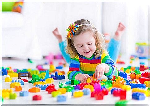 little girl playing with bricks