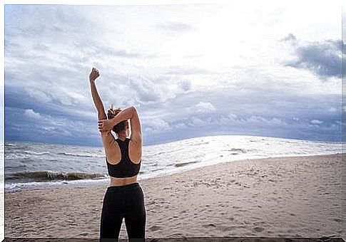 woman exercising on the beach