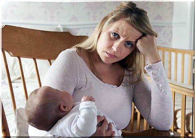 frustrated mother with baby on her arm