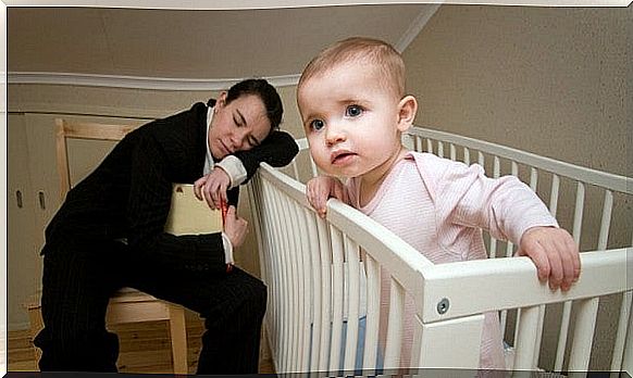 tired mother on the edge of cot