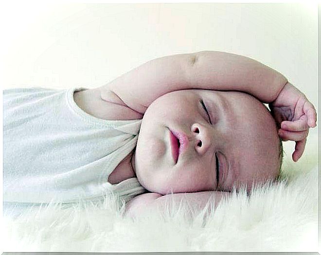 baby sleeping with arm over head