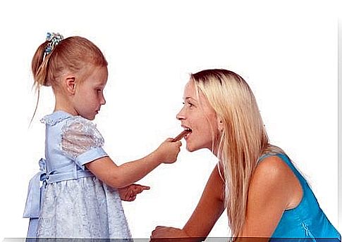 girl gives her mother a snack