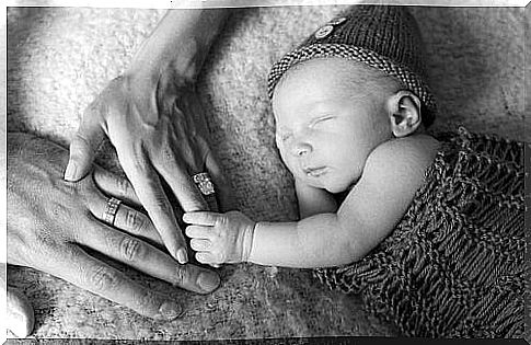 Baby holding finger